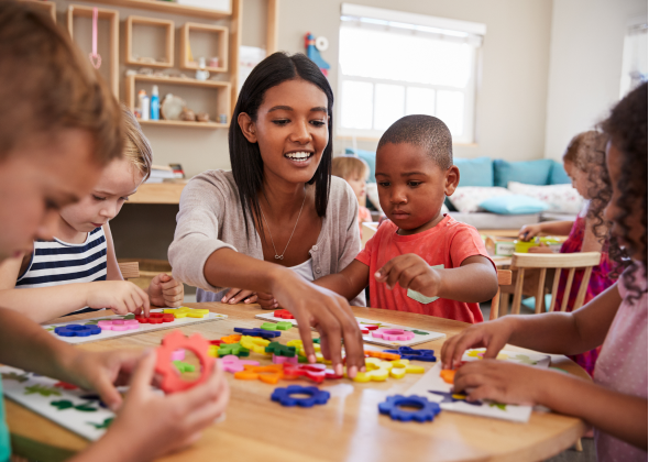 Child mentor interacts with children play